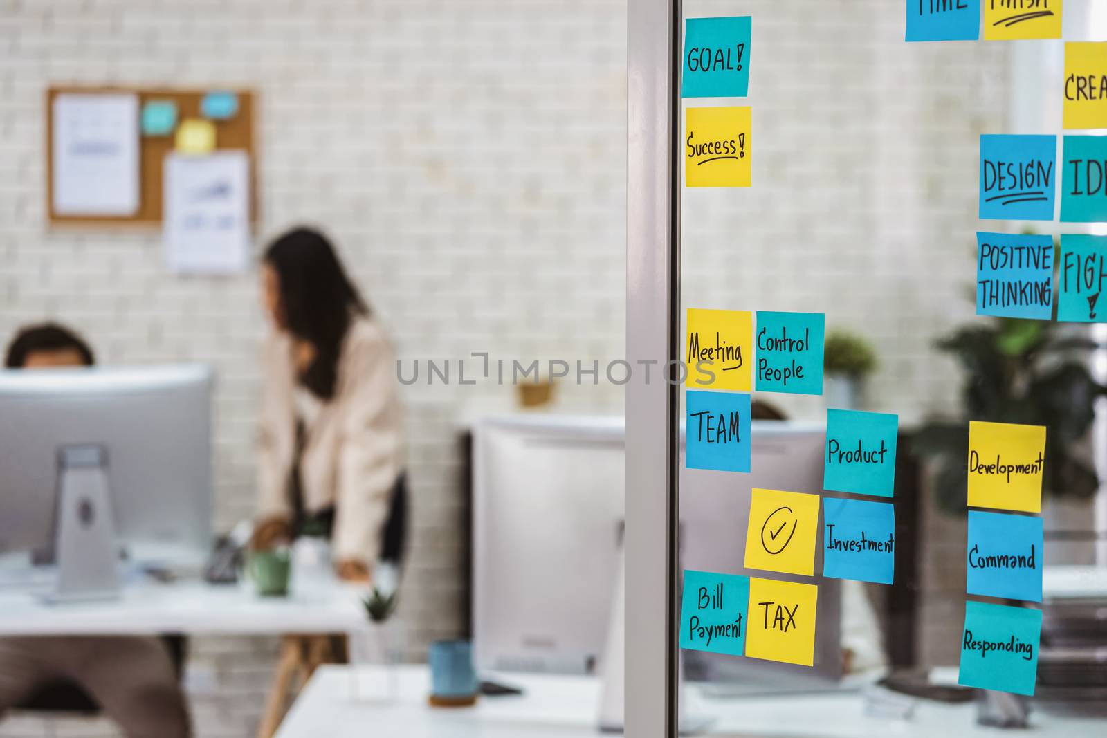 Various post it notes of business strategy wording over the glas by Tzido