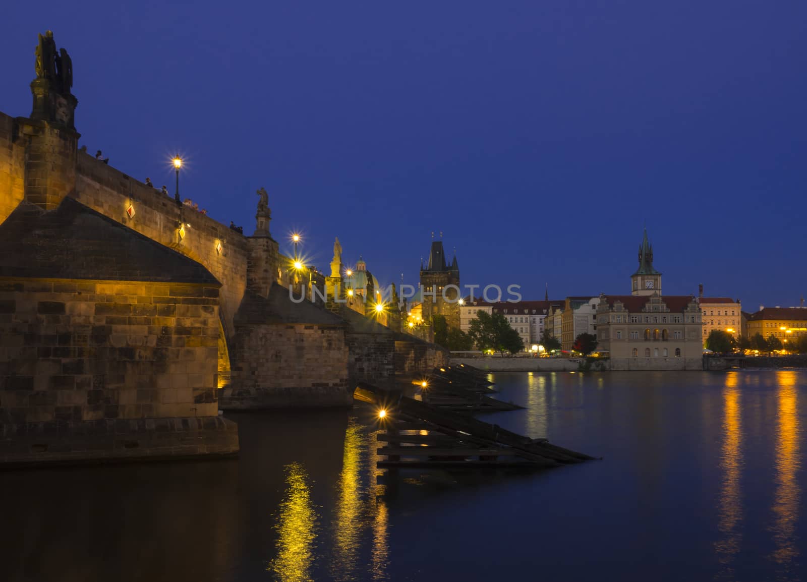 View of iluminated Charles Bridge in Prague from Kampa, Czech Republic. Gothic Charles Bridge is most visited sights in Prague. Architecture and landmark of Prague, night blue hour after sunset, long exposure
