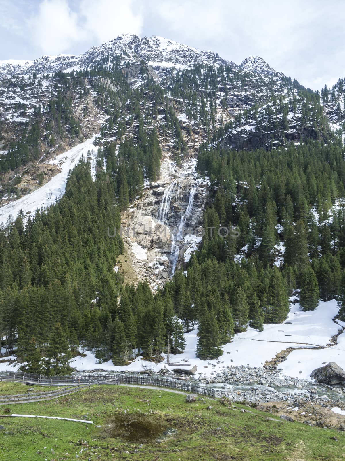 GRAWA Wasserfall Glacier Waterfall situated in Stubai Valley, Tyrol, Austria. Spring mountain river and trees landscape natural environment. Hiking in the alps