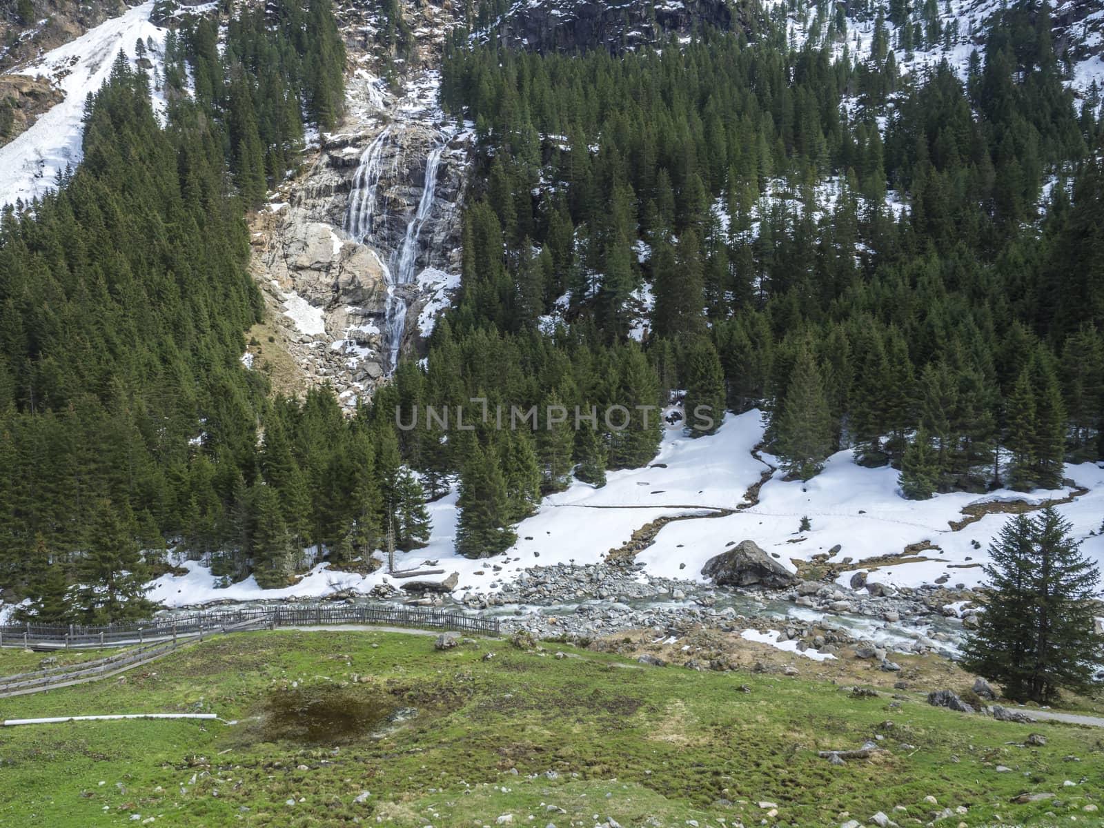 GRAWA Wasserfall Glacier Waterfall situated in Stubai Valley, Tyrol, Austria. Spring mountain river and trees landscape natural environment. Hiking in the alps