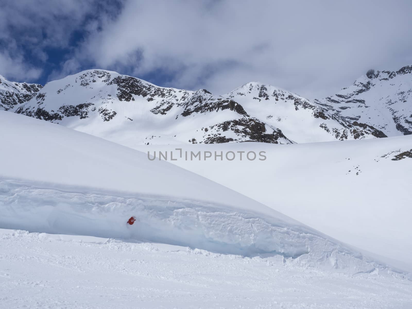 Winter landscape with empty red piste sign, snow covered mountain slopes, spring sunny day at ski resort Stubai Gletscher, Stubaital, Tyrol, Austrian Alps