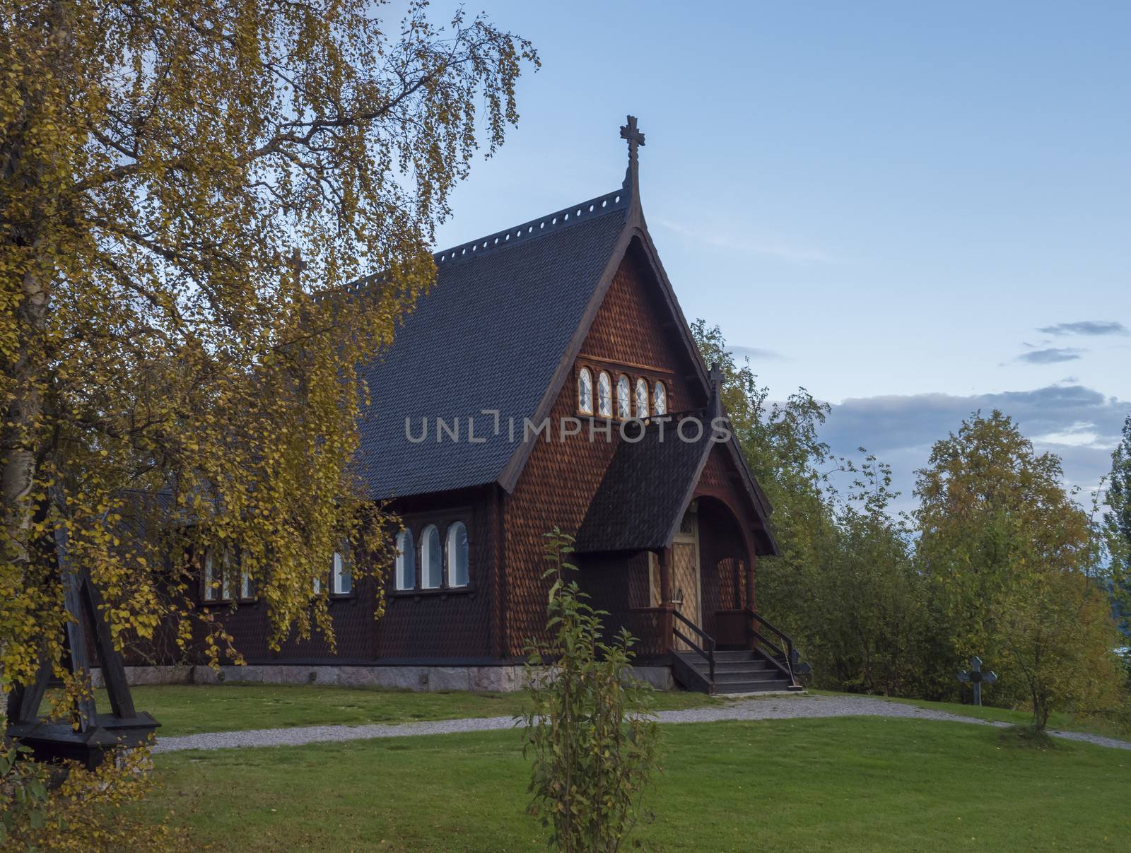 Traditional wooden Church in Kvikkjokk built in 1906, located in northern Sweden Lapland. End of gamous Kungsleden trail passes over the village. Early autumn, golden hour