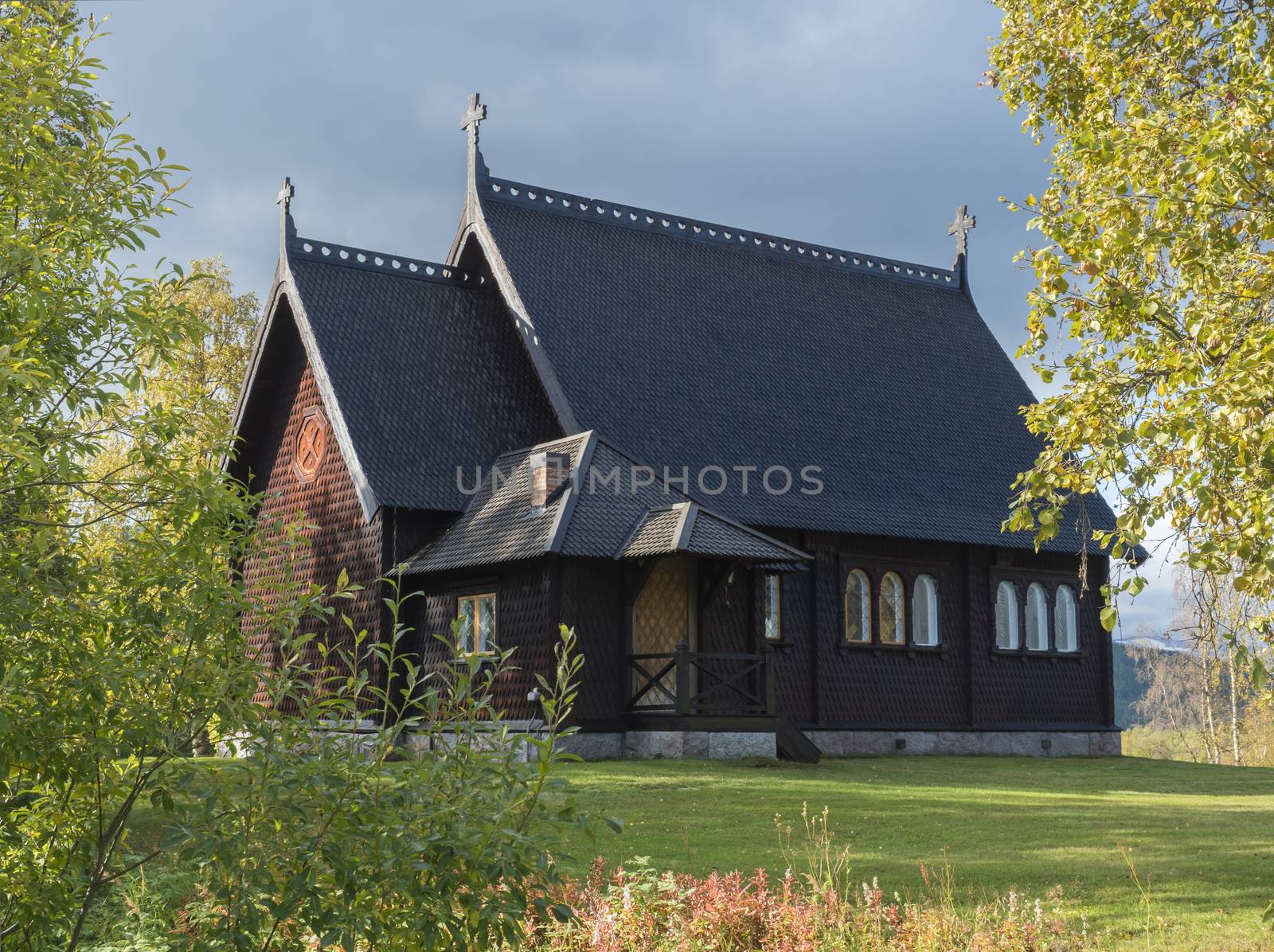 Traditional wooden Church in Kvikkjokk built in 1906, located in northern Sweden Lapland. End of gamous Kungsleden trail passes over the village. Early autumn, golden hour