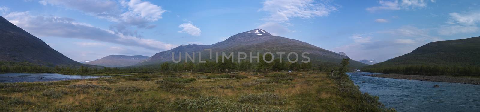 Wide panoramatic Lapland nature landscape with angler fisherman and small tent at blue Tjaktjajakka river, Kaitumjaure, birch tree forest and mountain Sanjartjakka. Summer at North sweden wilderness. by Henkeova