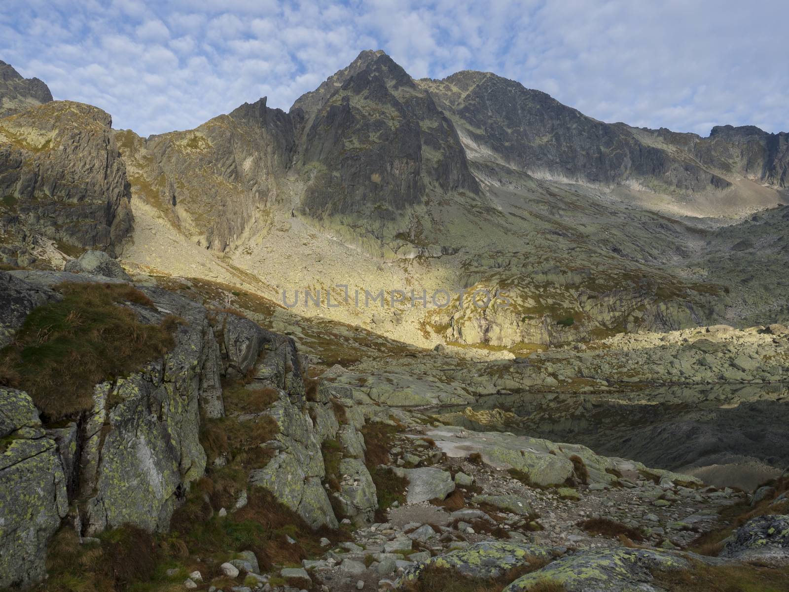 view on mountain lake Prostredne Spisske pleso at the end of the hiking route to the Teryho Chata mountain shelter in the High Tatras in Slovakia.