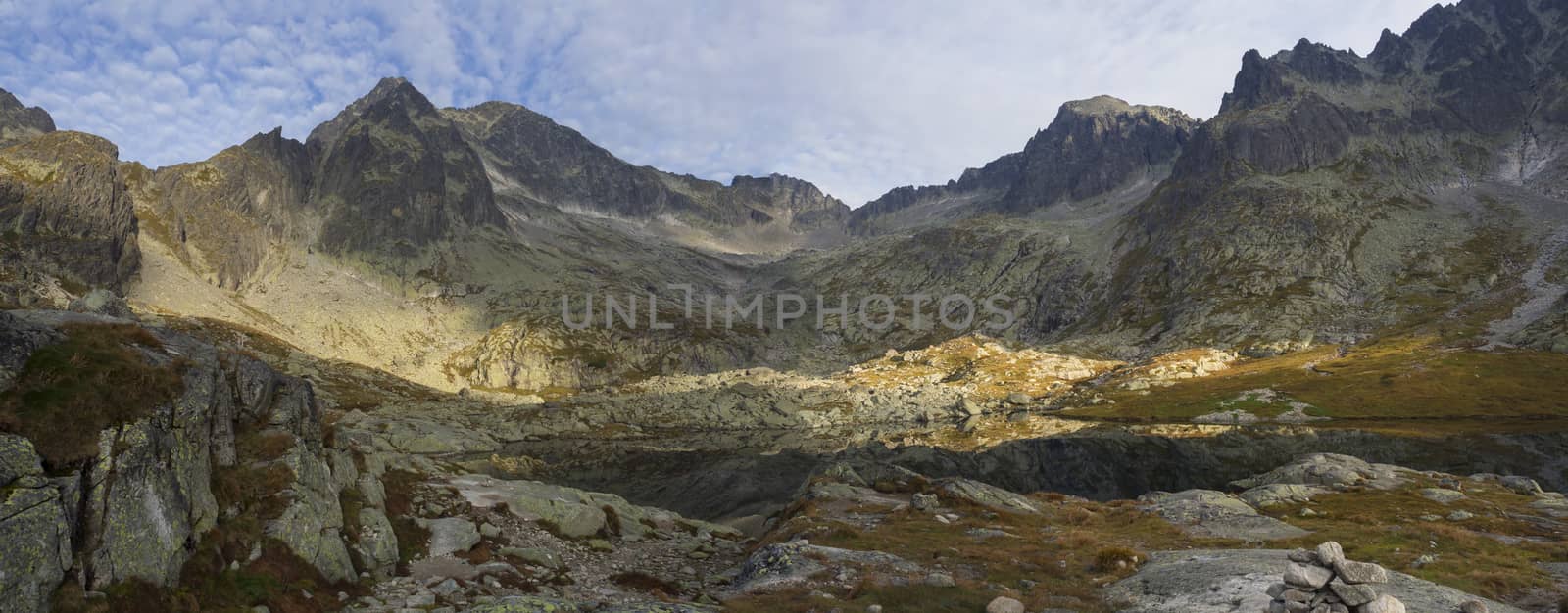Panoramic view on mountain lake Prostredne Spisske pleso at the end of the hiking route to the Teryho Chata mountain shelter in the High Tatras in Slovakia by Henkeova