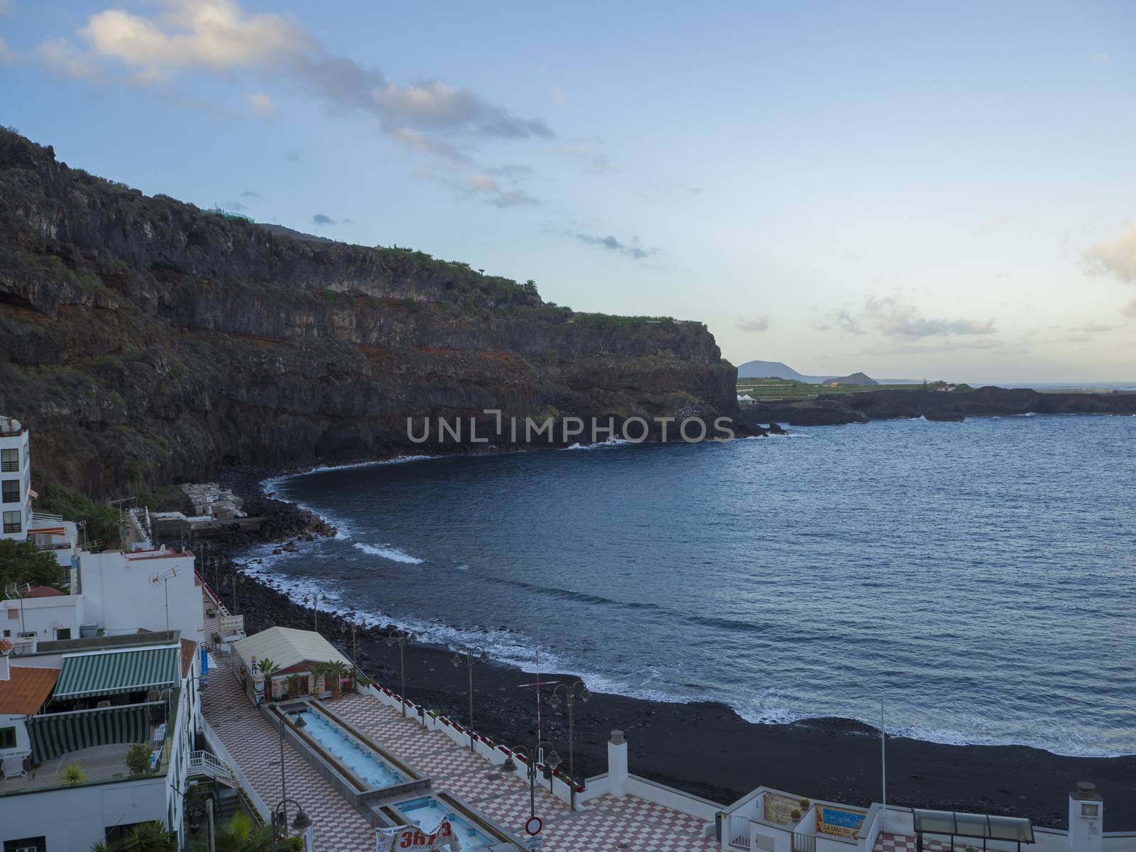 Spain, Canary islands,icod de lod vinos, December 19, 2017, view on Playa de San Marcos beach with black sand promenade and lava cliffs early morning