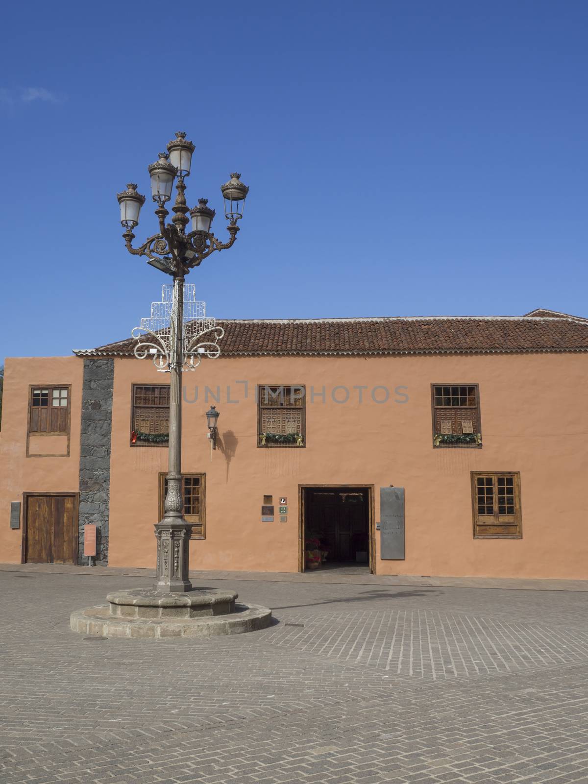 main square in old village garachico with traditional house street lamp with christmas decoration and blue sky background by Henkeova