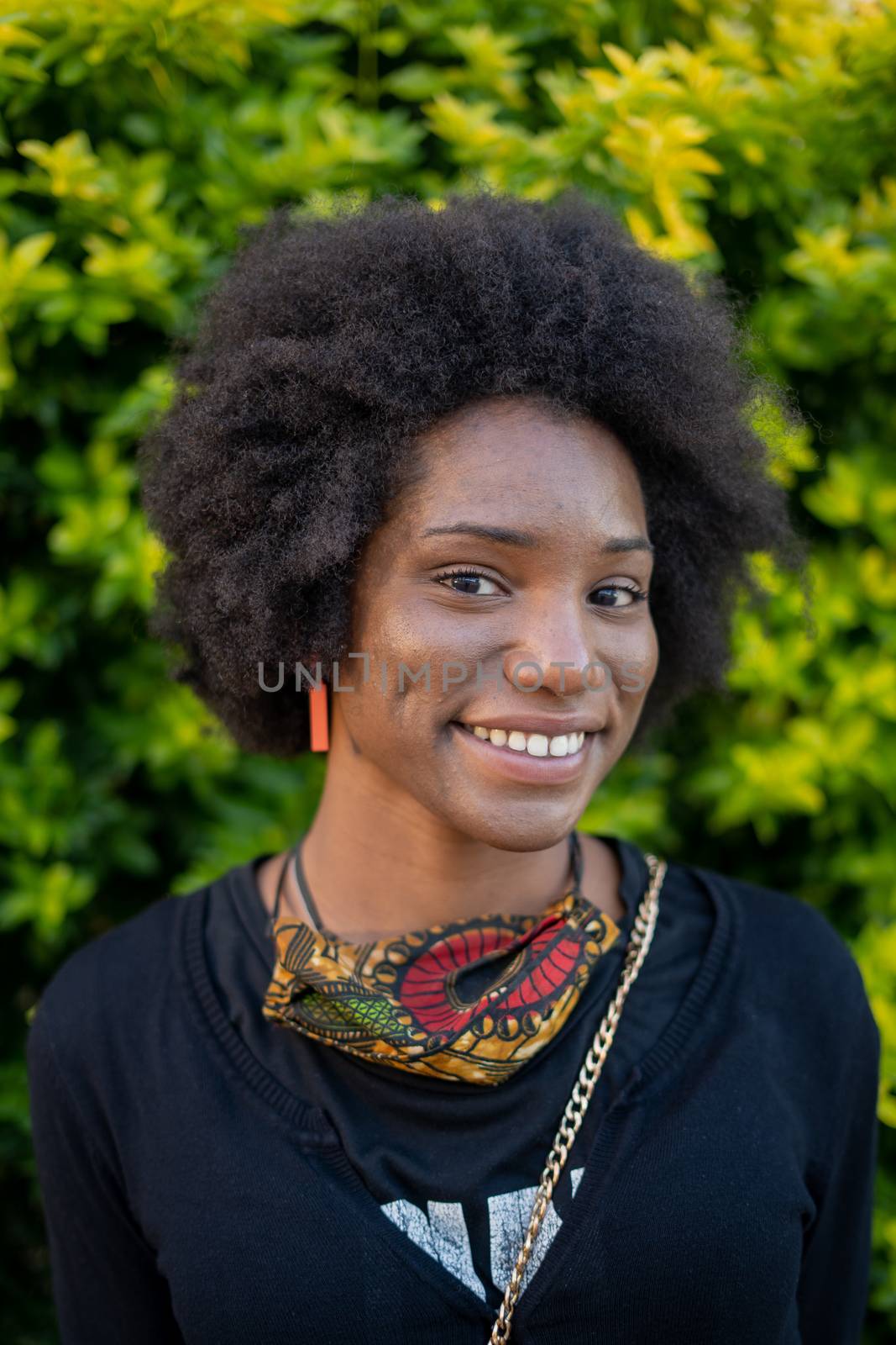 Vertical portrait of smiling african woman with natural hair by rushay