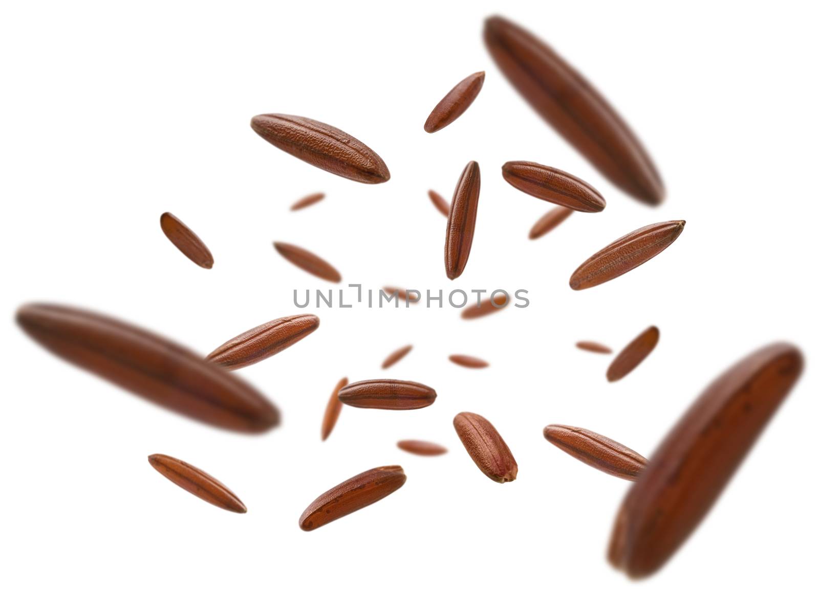 Raw brown rice levitates on a white background by butenkow