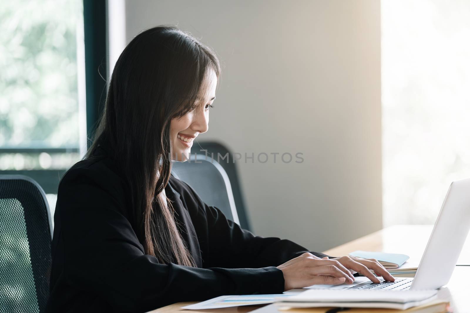 Asian woman using laptop computer for business analyst by nateemee