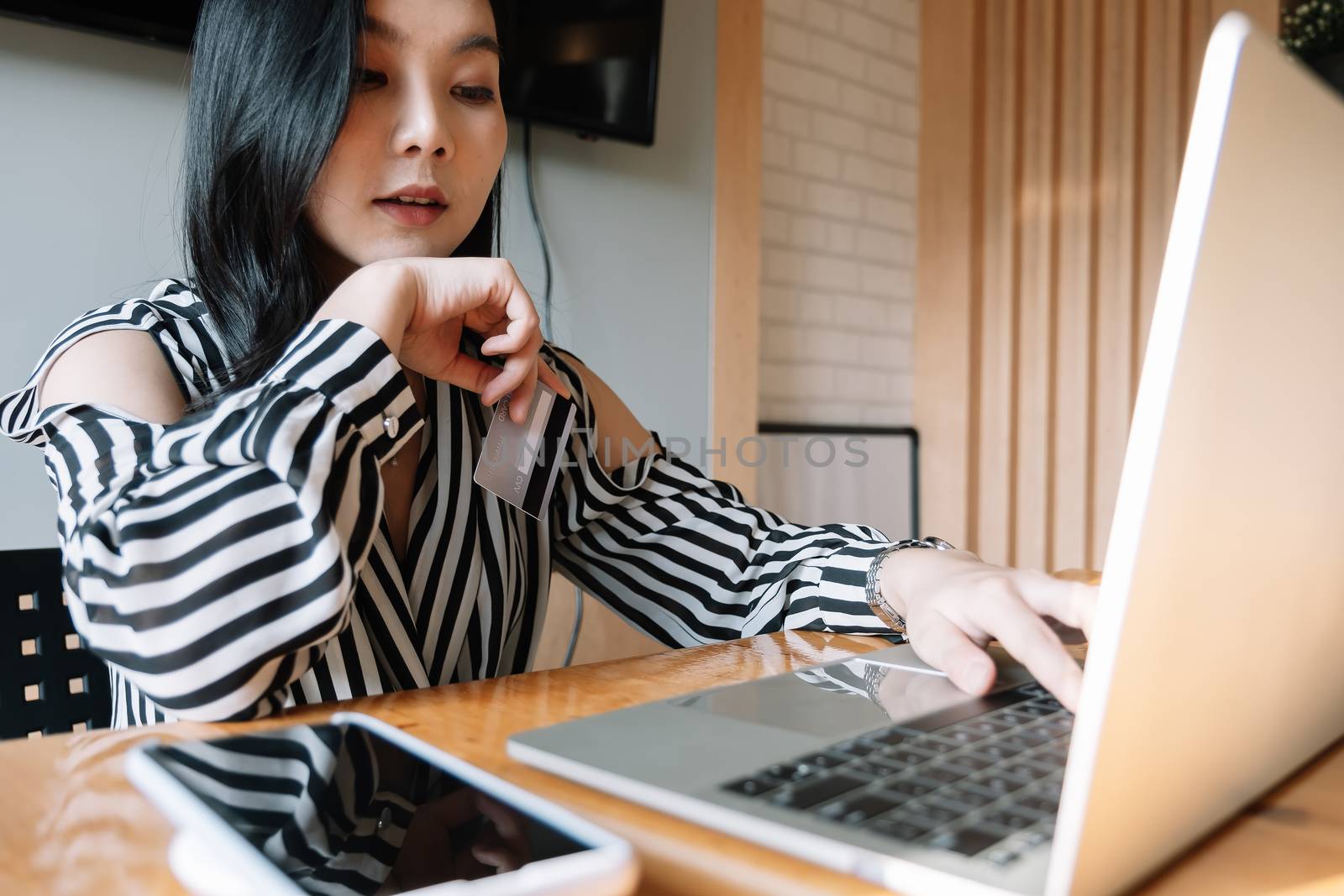 close up woman using laptop and credit card for pay online shopping e-commerce online payment concept