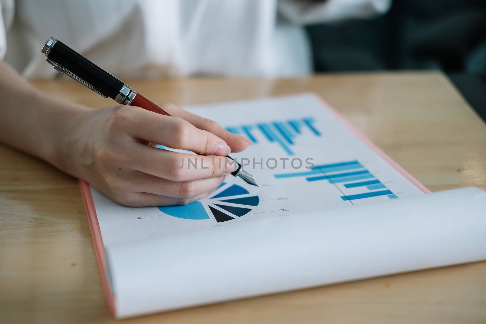 Close up Businesswoman Analysts Financial document for marketing plan.