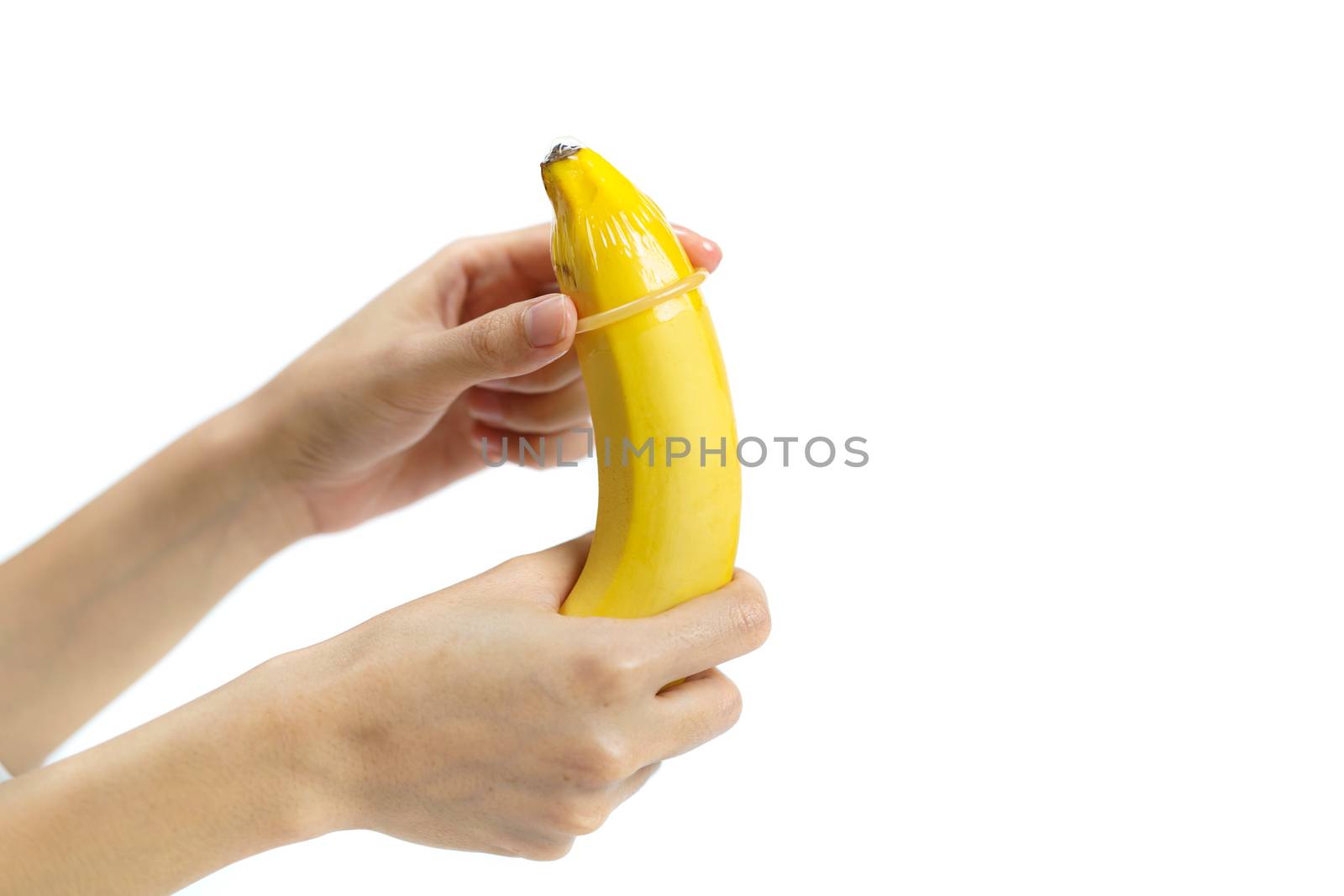 Condom on banana on white background, Safe sex concept. isolated by sirawit99