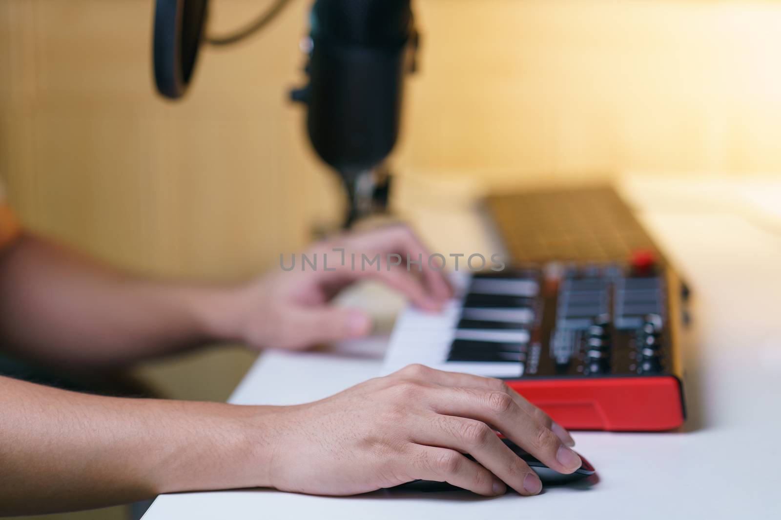 Hand using mouse and sound mixing console board. Equipment for the music studio.