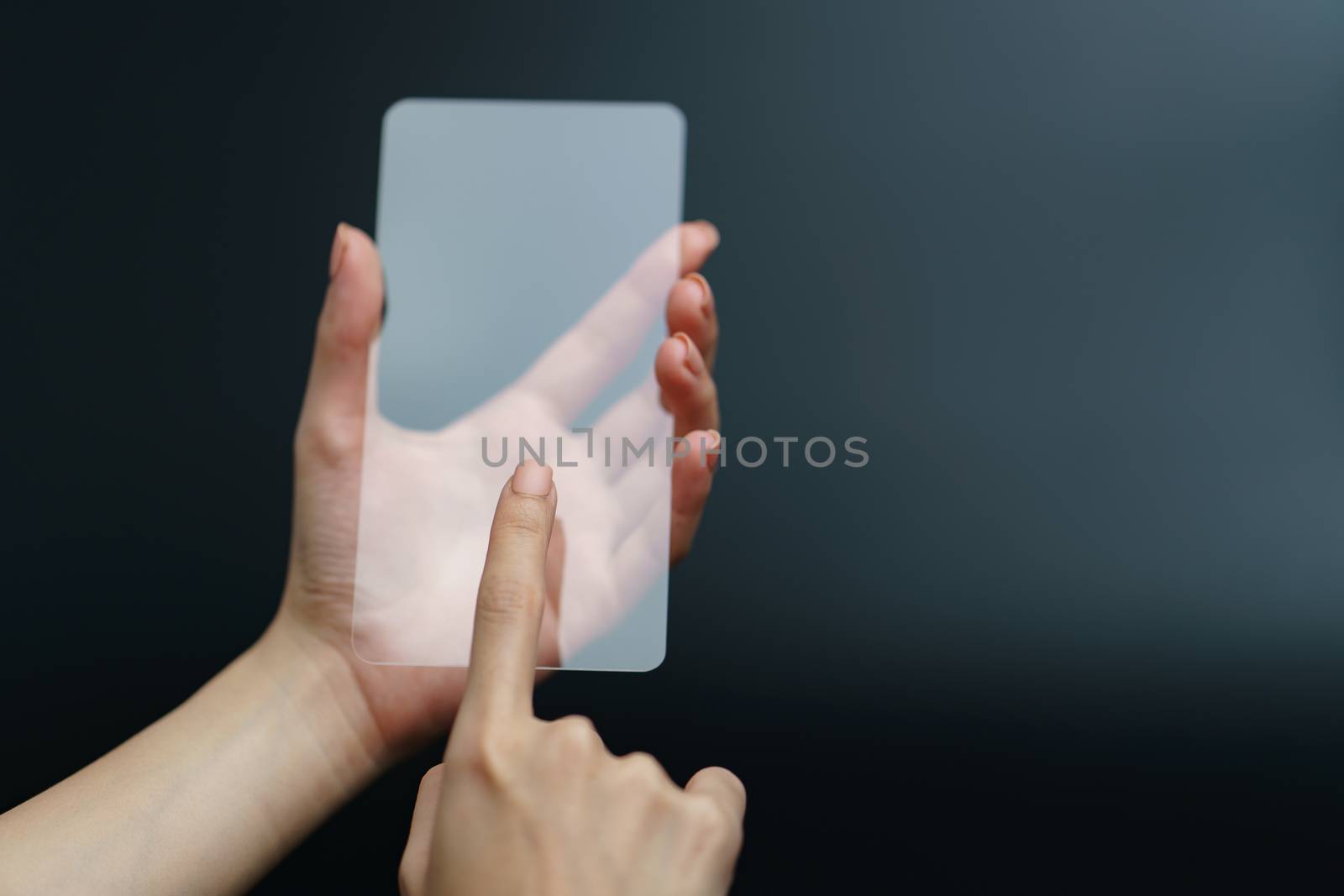 Hand holding and showing transparent smartphone. Business, technology concept.