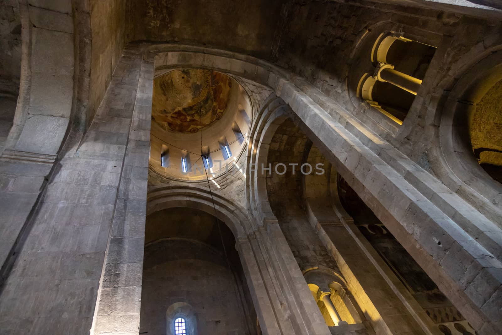 The Svetitskhoveli Cathedral, Mtskheta Georgia 05/10/2019 beautiful interior image looking up to the central dome with murals and icons.