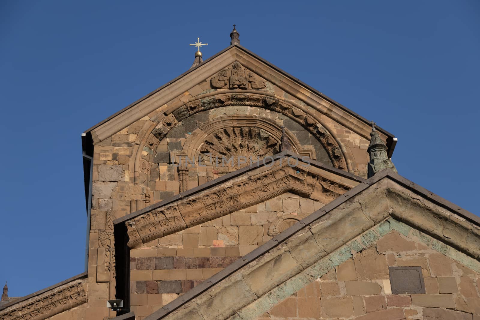 The Svetitskhoveli Cathedral, Mtskheta beautiful exterior looking up to crucifix on top of cathedral with exquisite stone work