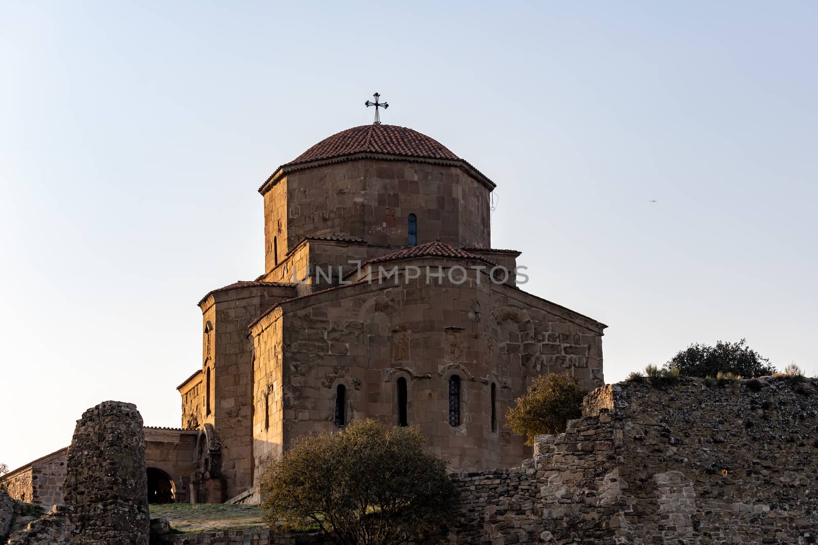 Jvari Monastery is a sixth-century Georgian Orthodox monastery near Mtskheta, eastern Georgia. Late afternoon sun highlighting textures of warm brown stones