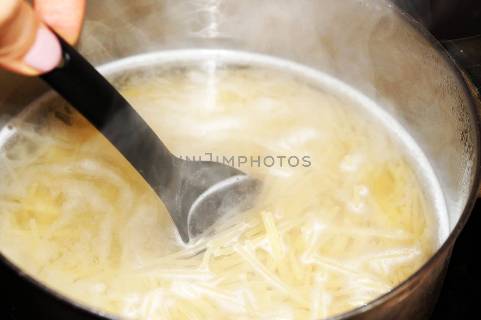 cooking spaghetti in a saucepan close-up