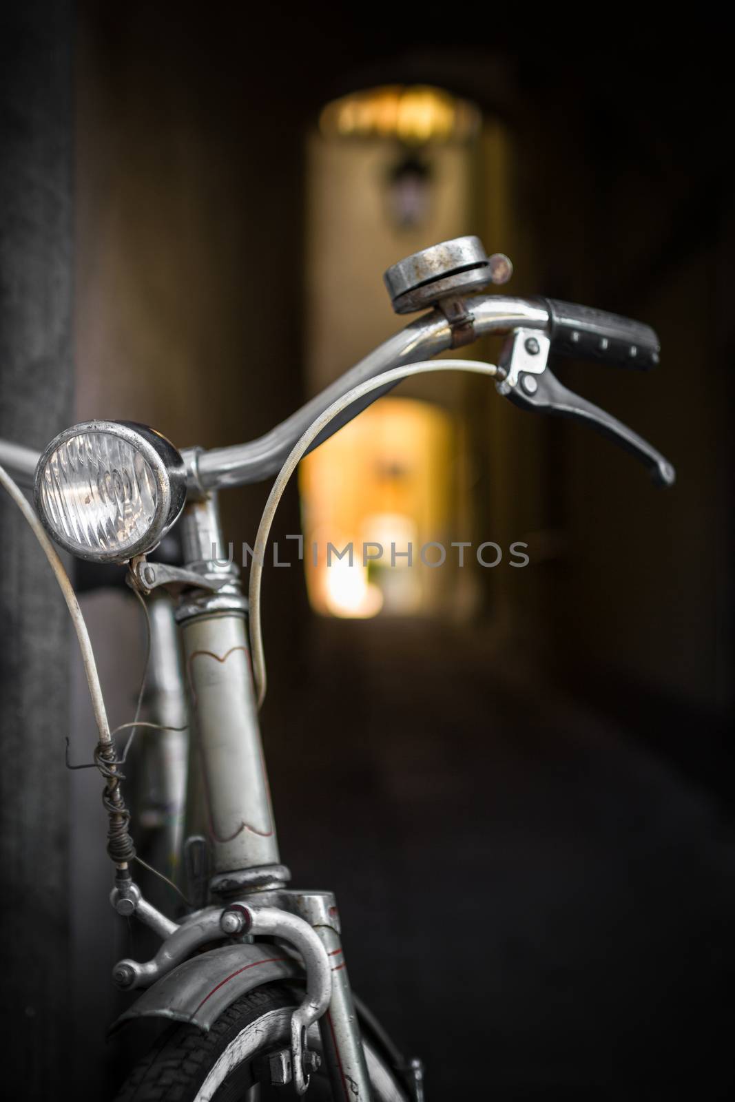 An old bicycle leaning against a wall.