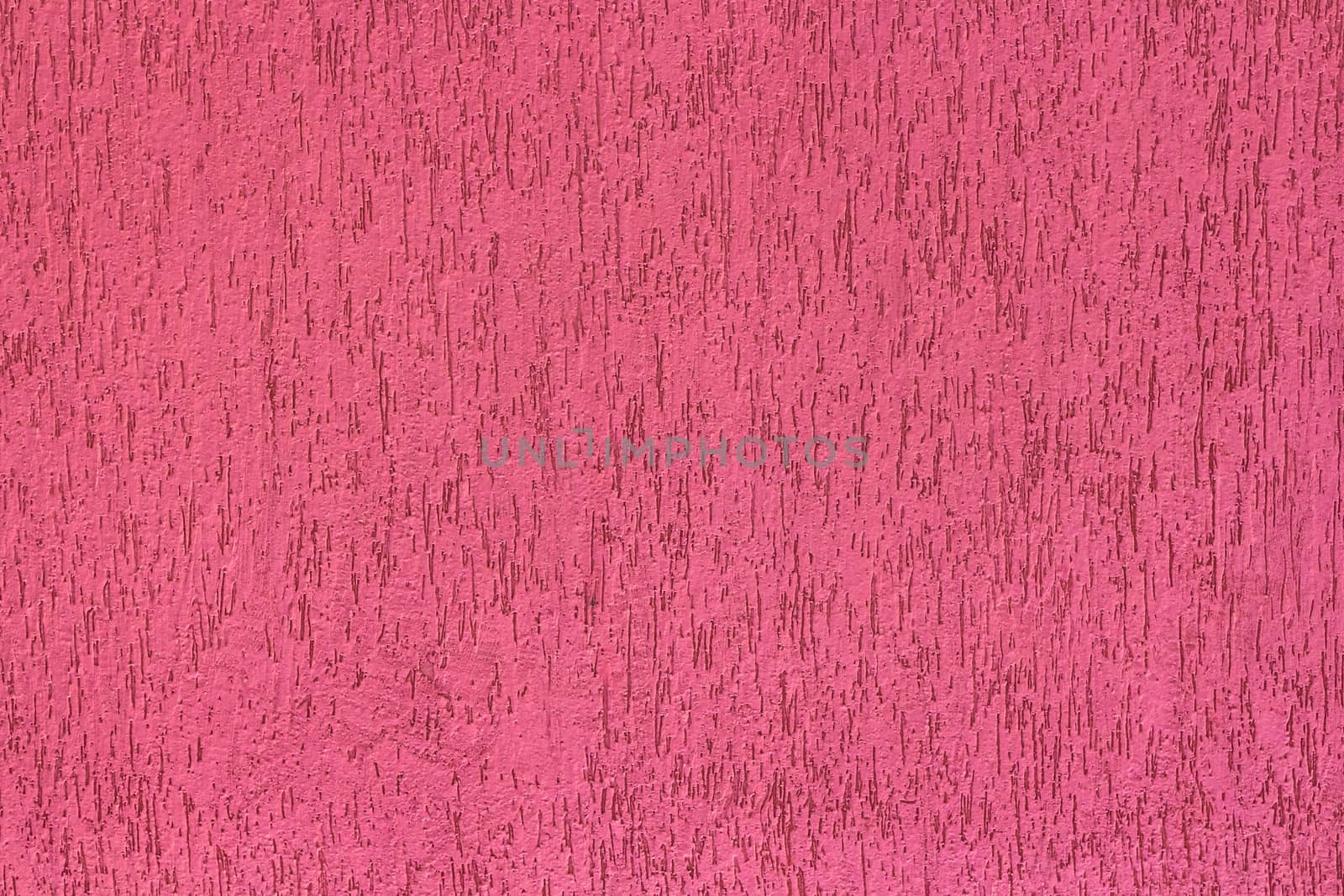 Front view of a pink wall with irregular texture.