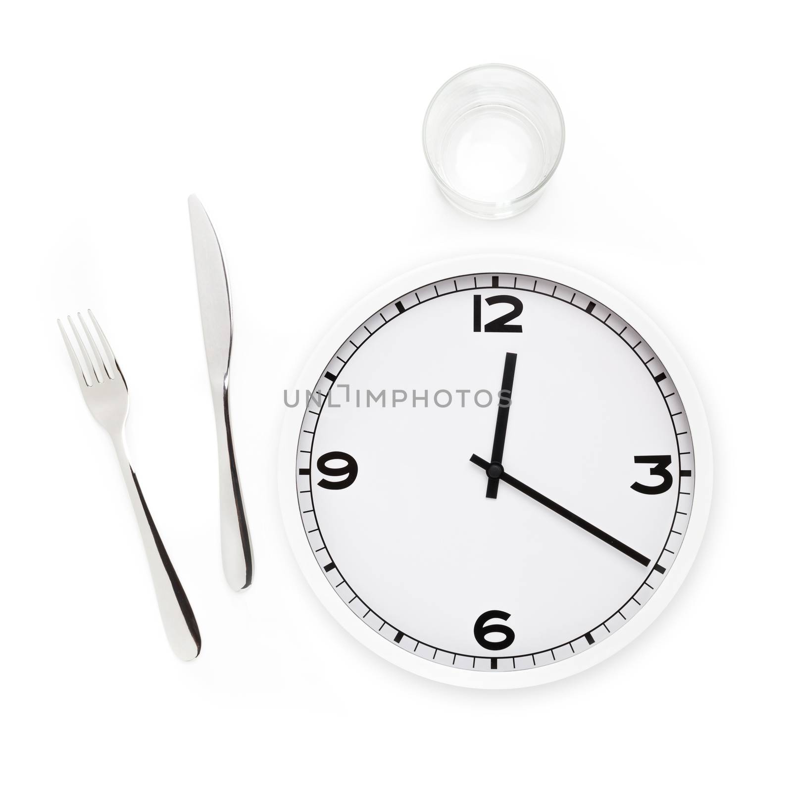 Fork, knife, glass, and white round clock isolated in white background. Time to eat concept.