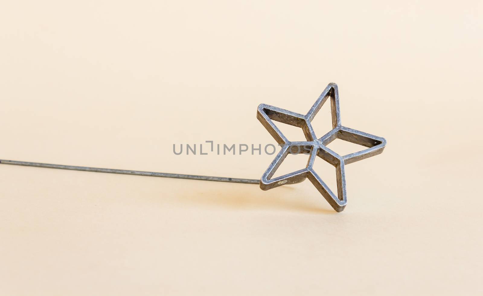 antique star-shaped metal mold for making pancakes