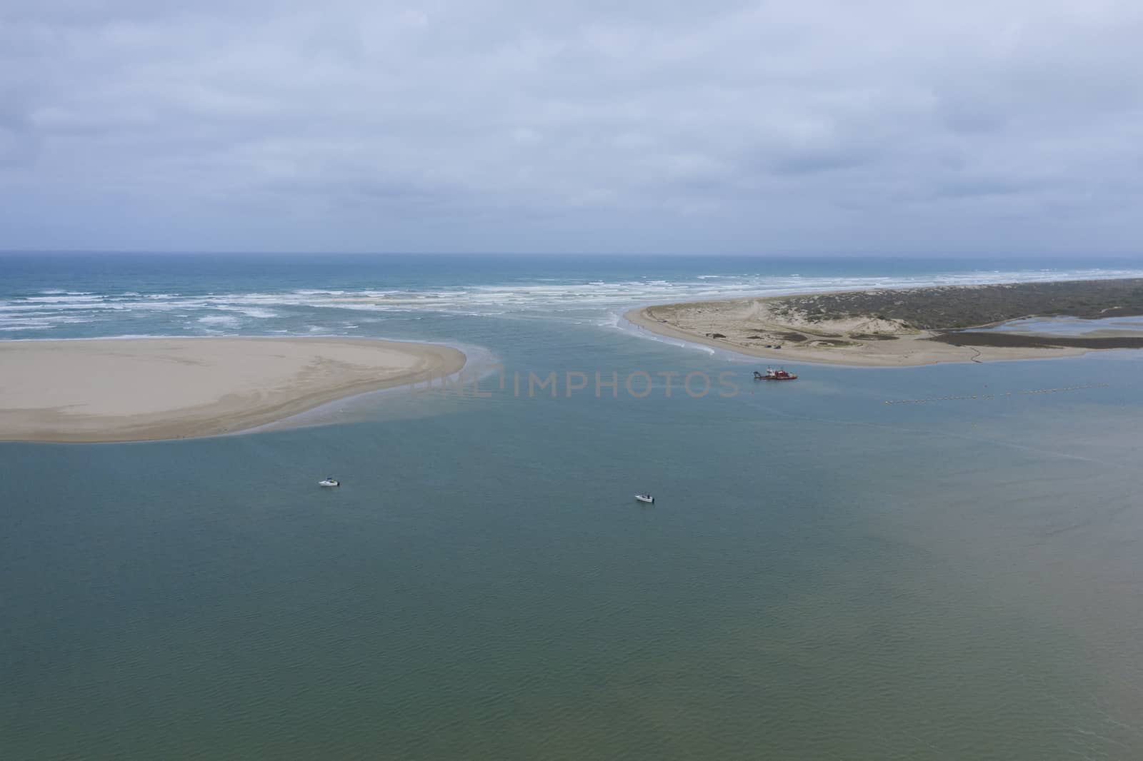 Aerial view of a sand dredger boat at the mouth of the River Murray in regional Australia by WittkePhotos