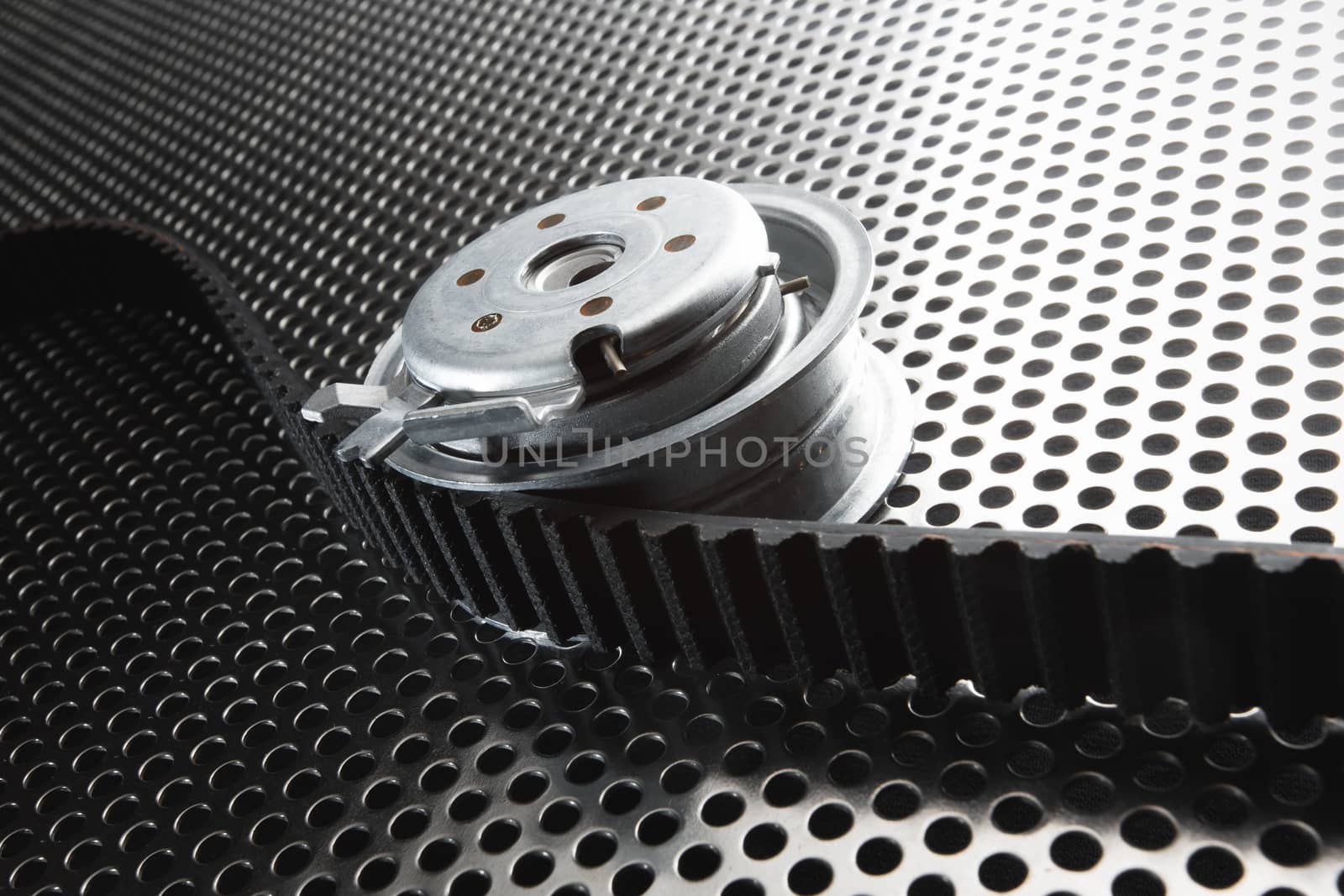 Bearing tensioner and timing belt on a metal surface by DmitrySteshenko