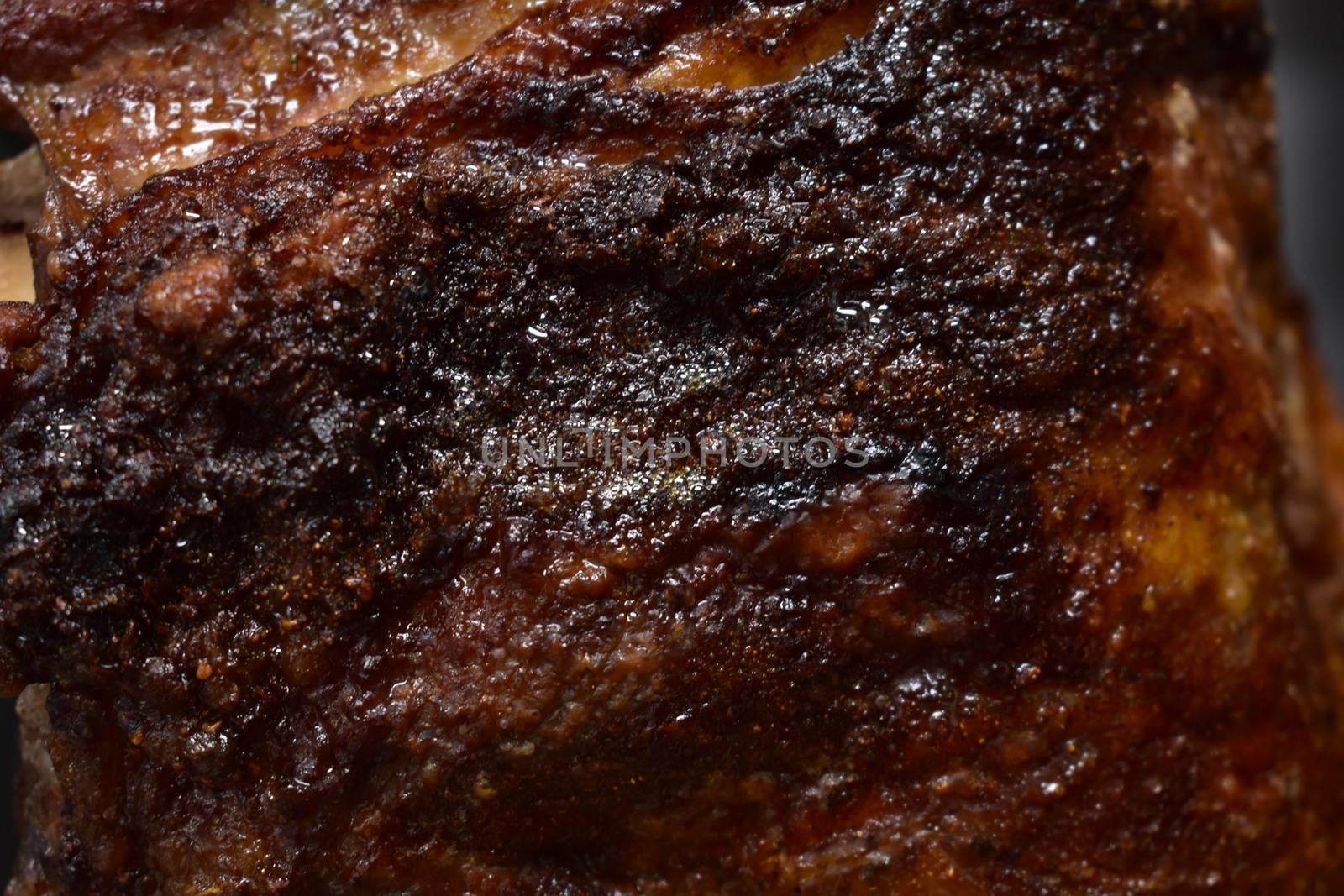 A Close Up of a Well-Done Rack of Ribs inside a Rotisserie