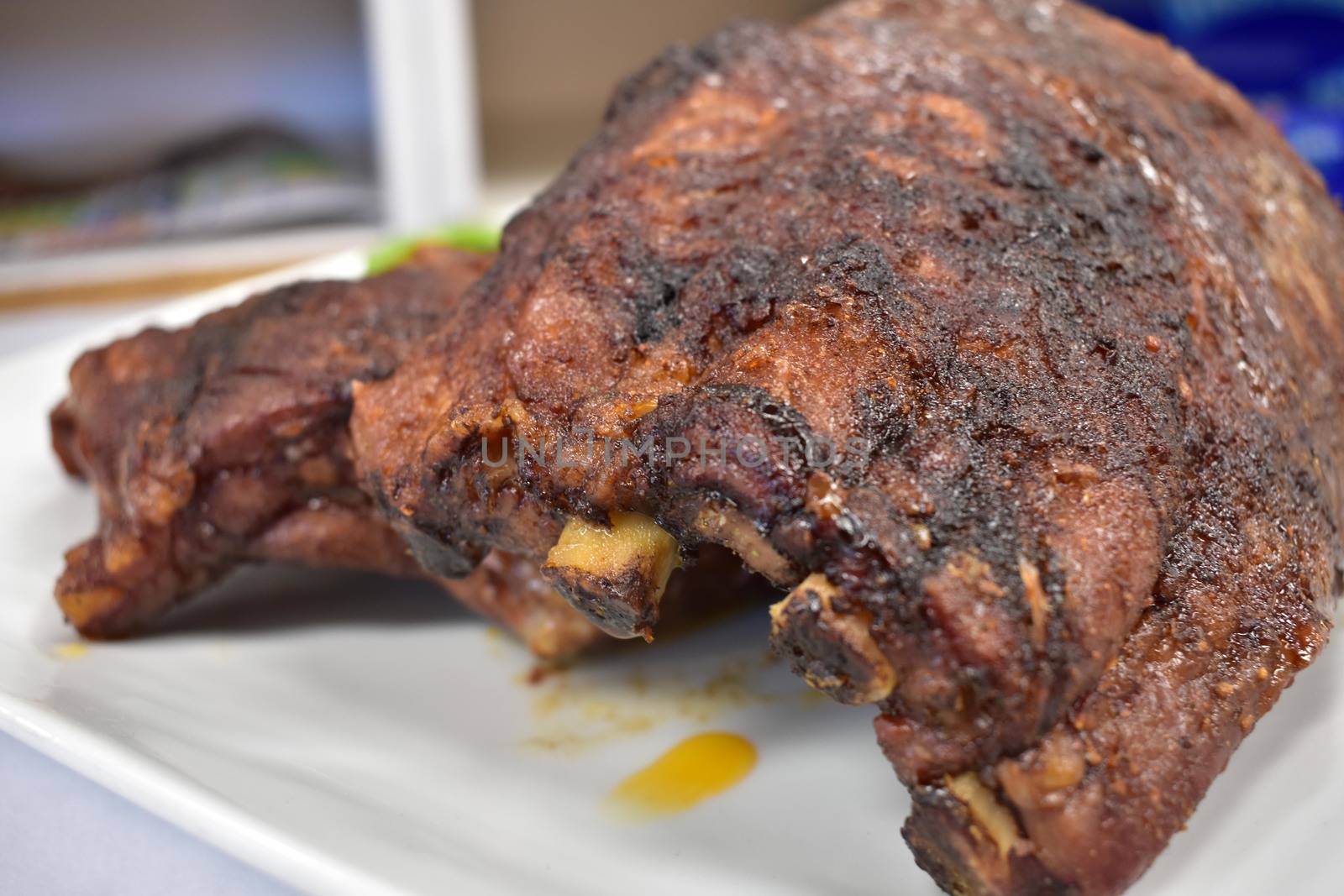 A Well-Done Rack of Ribs Plated on a White Background