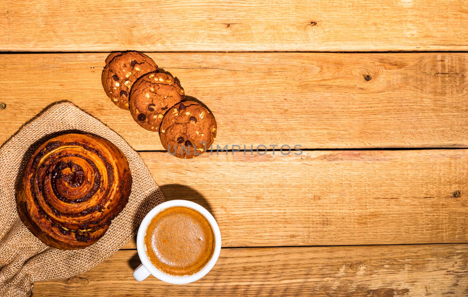 Fresh puff pastry on wooden table. Coffee, food and breakfast concept. Desserts, fresh pastries, biscuits and coffee. Top view and copy space