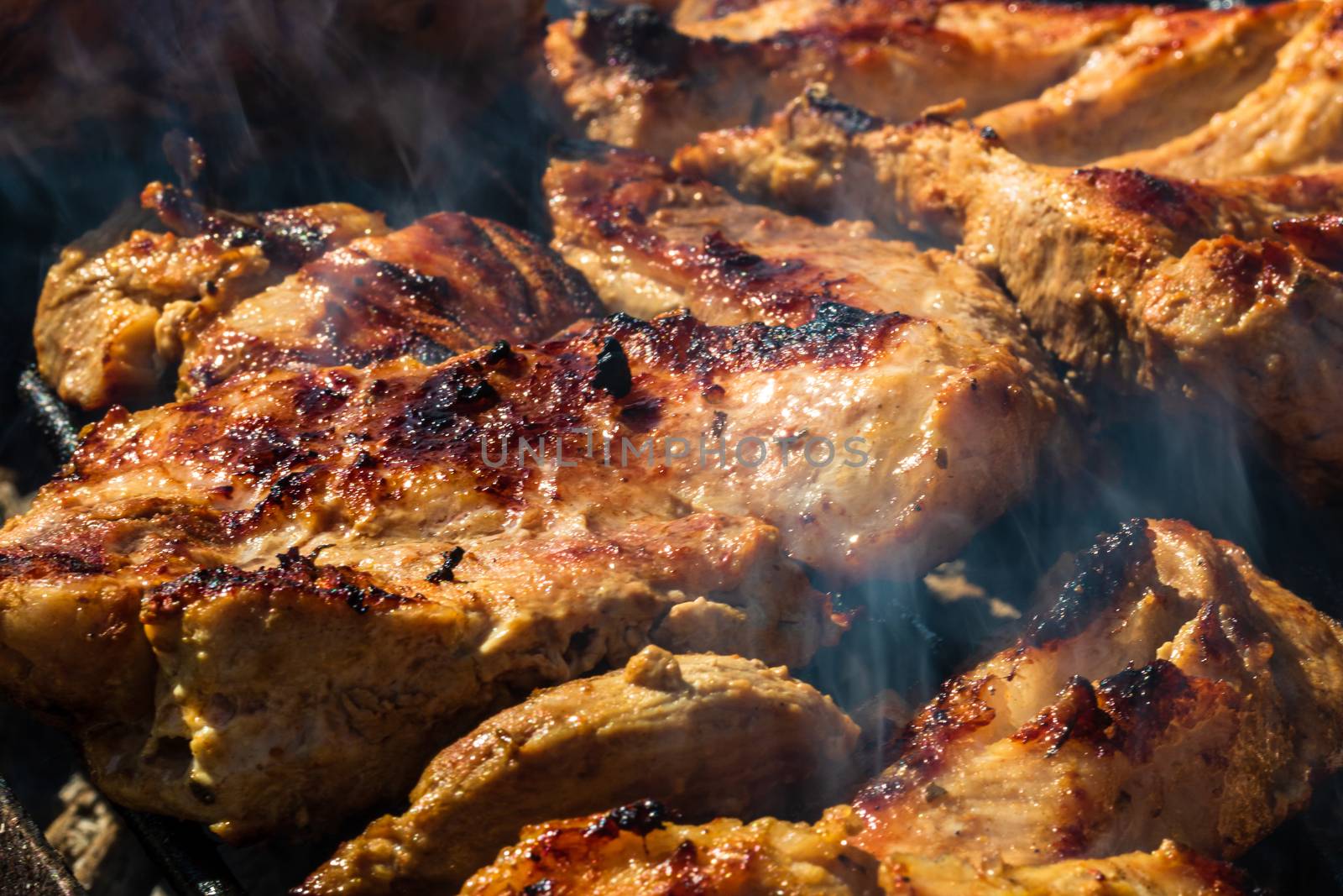 Chicken and pork steak grilled on a charcoal barbeque. Top view  by vladispas