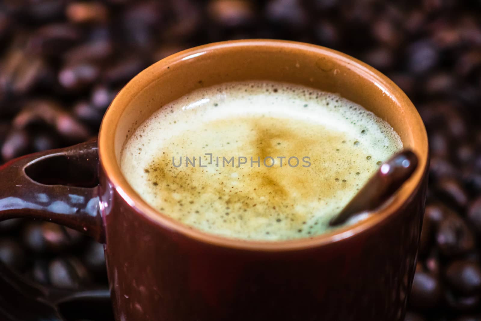 Close up of cup of coffee, roasted coffee beans on red backgroun by vladispas