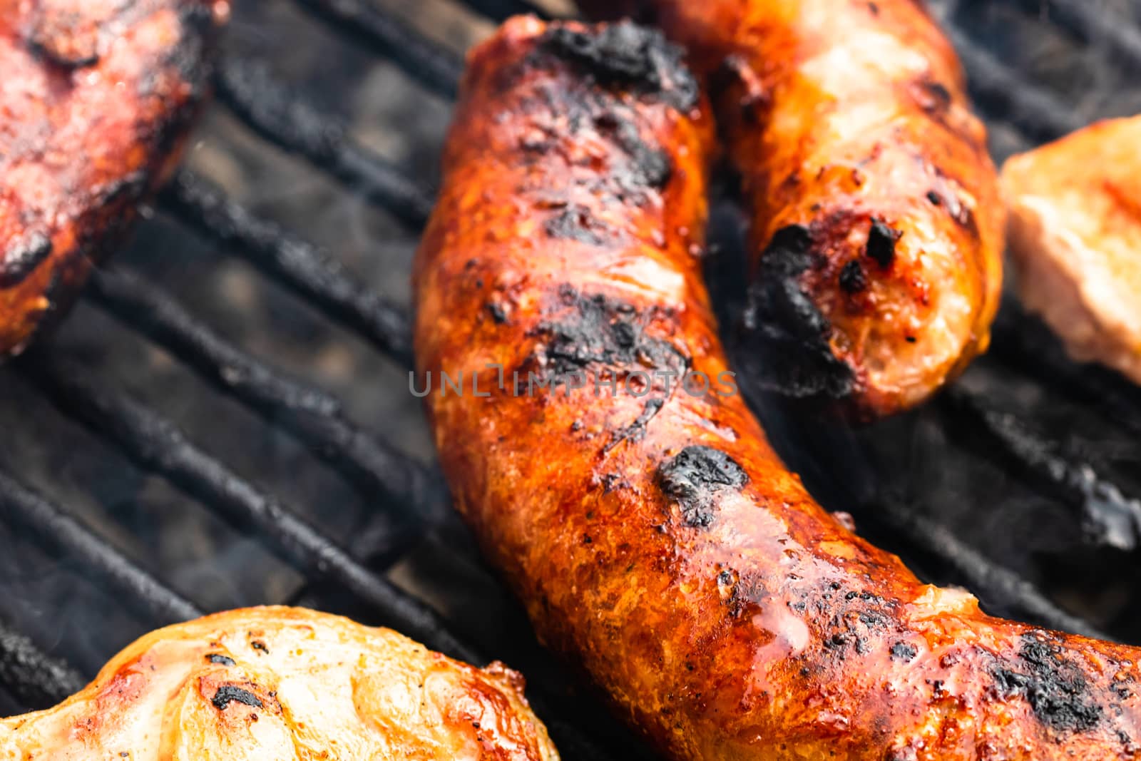 Close up on details of homemade sausages on barbecue grill. Barb by vladispas