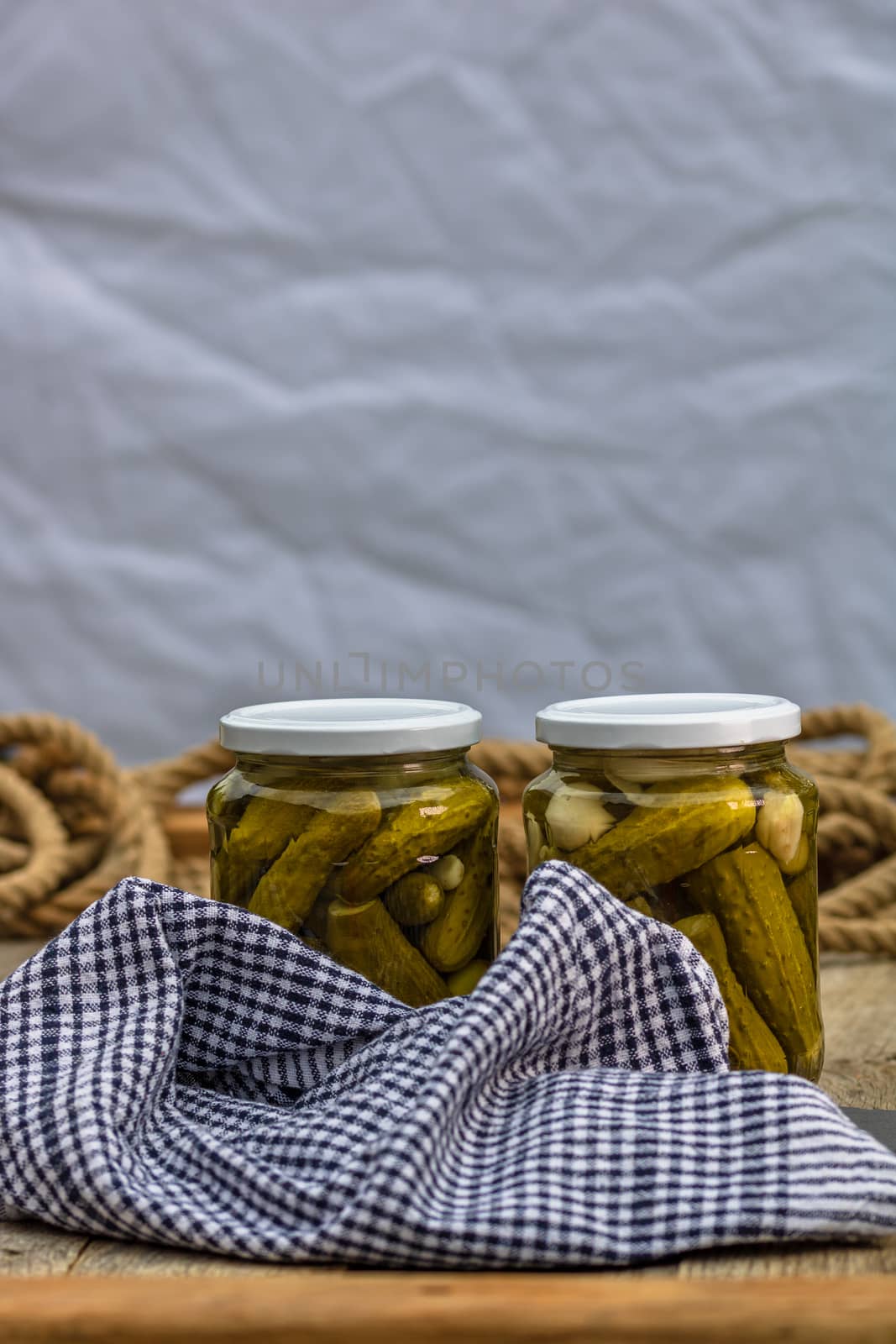 Glass jars with pickled red bell peppers and pickled cucumbers ( by vladispas