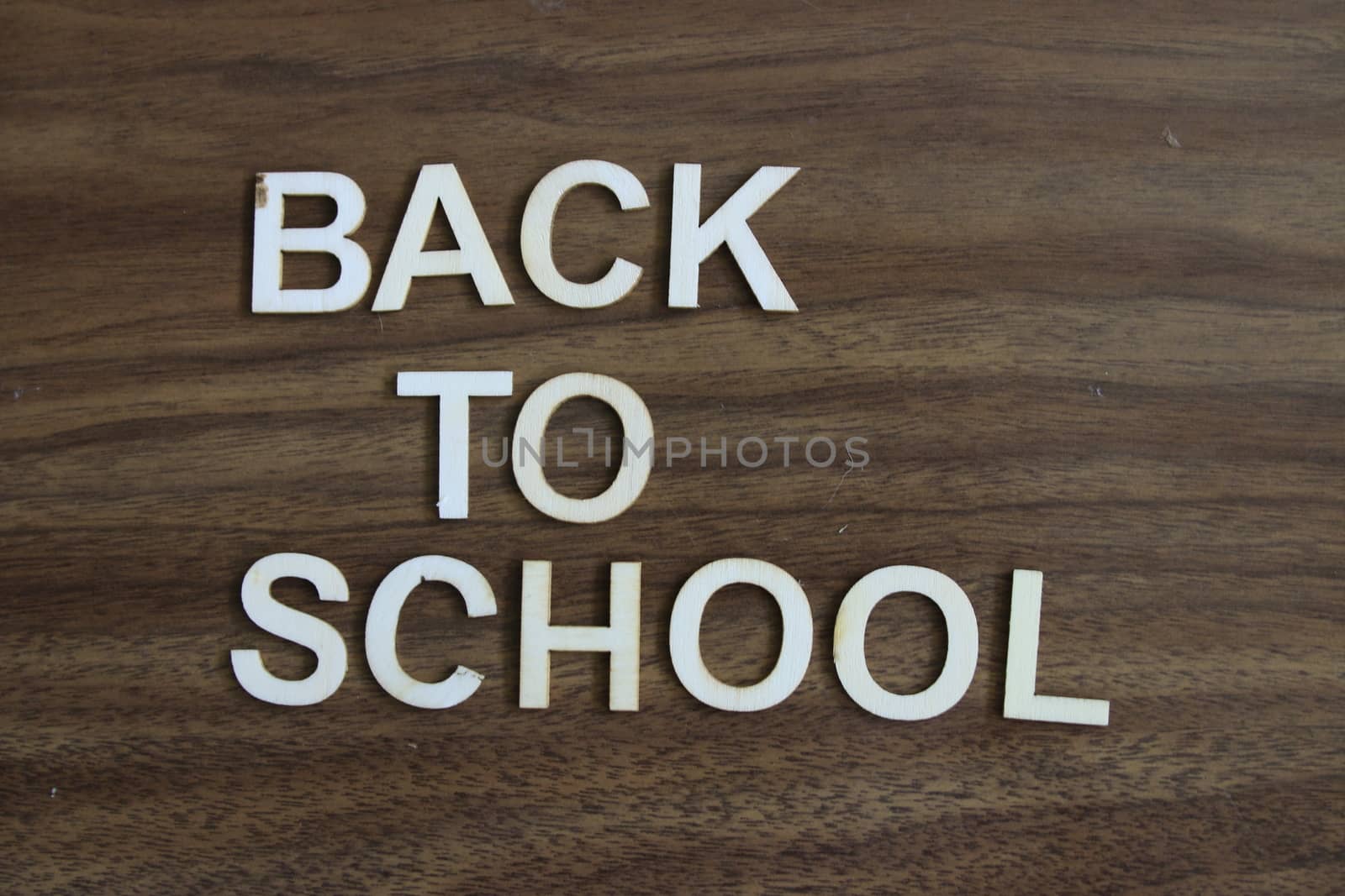 back to school wrote out on a wooden background. High quality photo