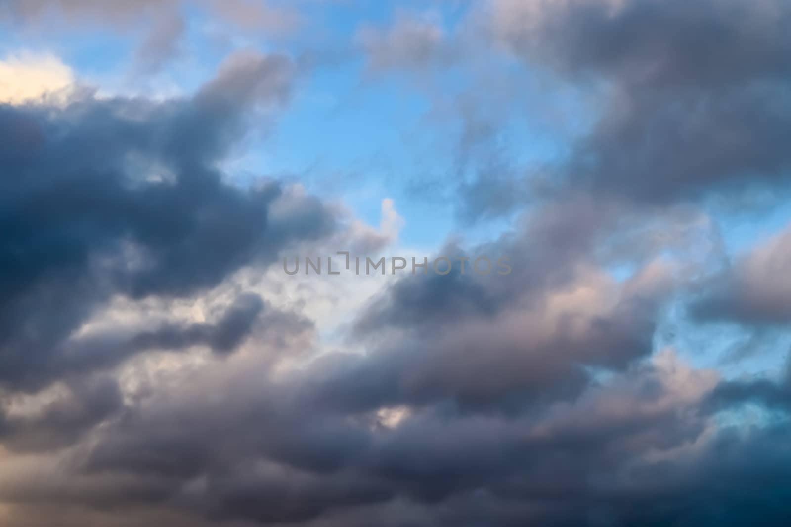 Beautiful panorama of orange and yellow clouds at sunrise and sunset in a blue sky