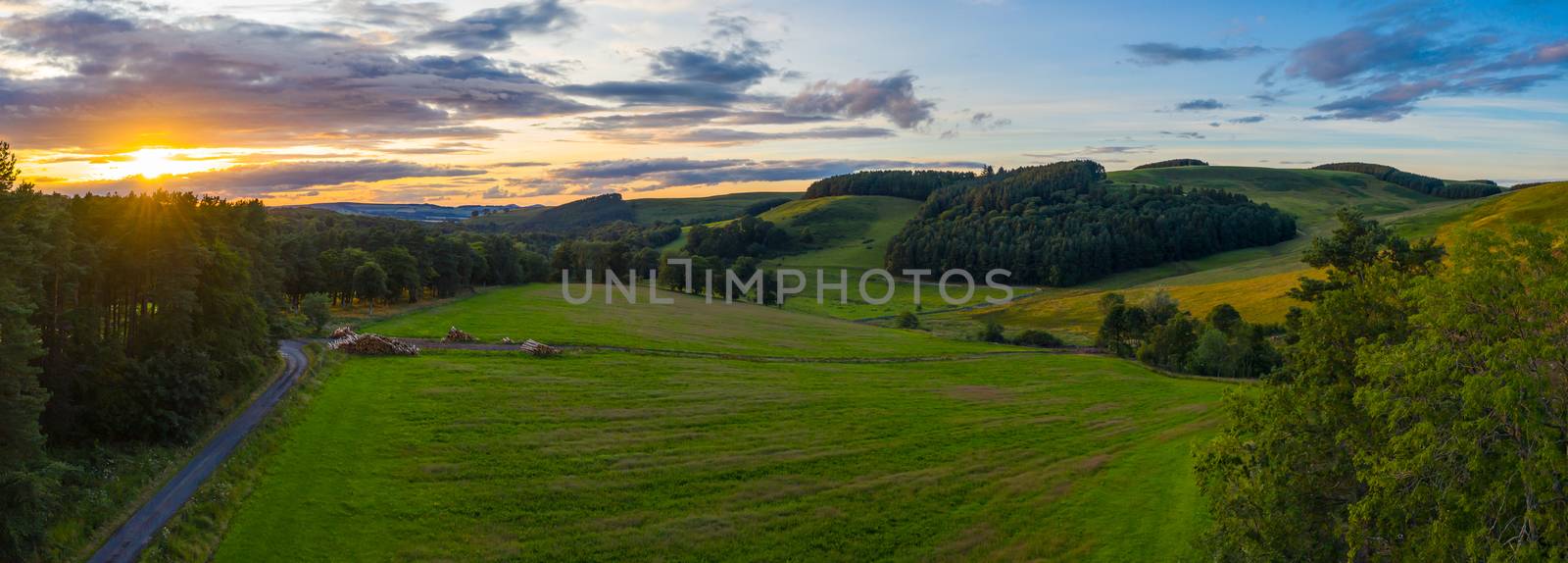 Panorama Of A Beautiful Sunset Over Gentle Rolling Hills In The Scottish Borders