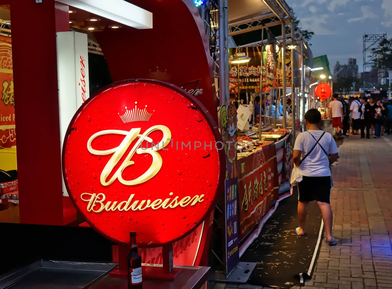 KAOHSIUNG, TAIWAN -- MARCH 2, 2018: An outdoor vendor at a night market sells grilled meat and Budweiser beer.

