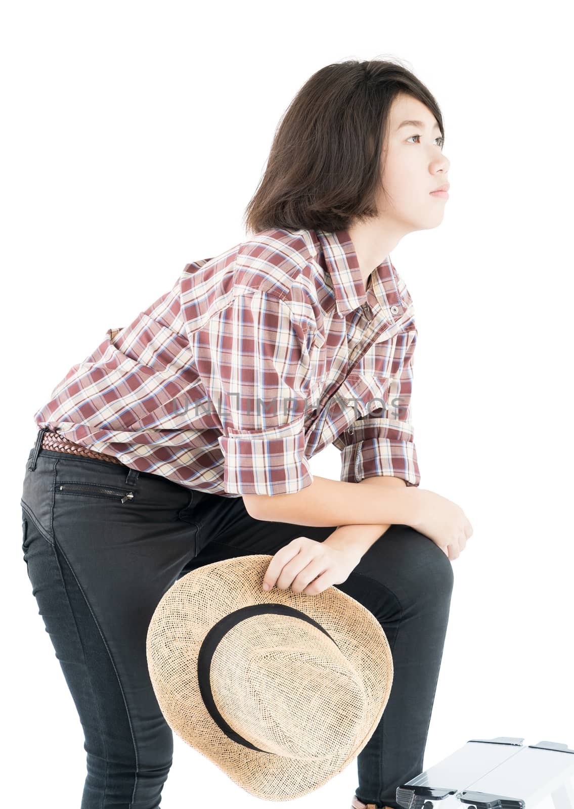 Young woman in a plaid shirt posing in studio on white backgroun by stoonn