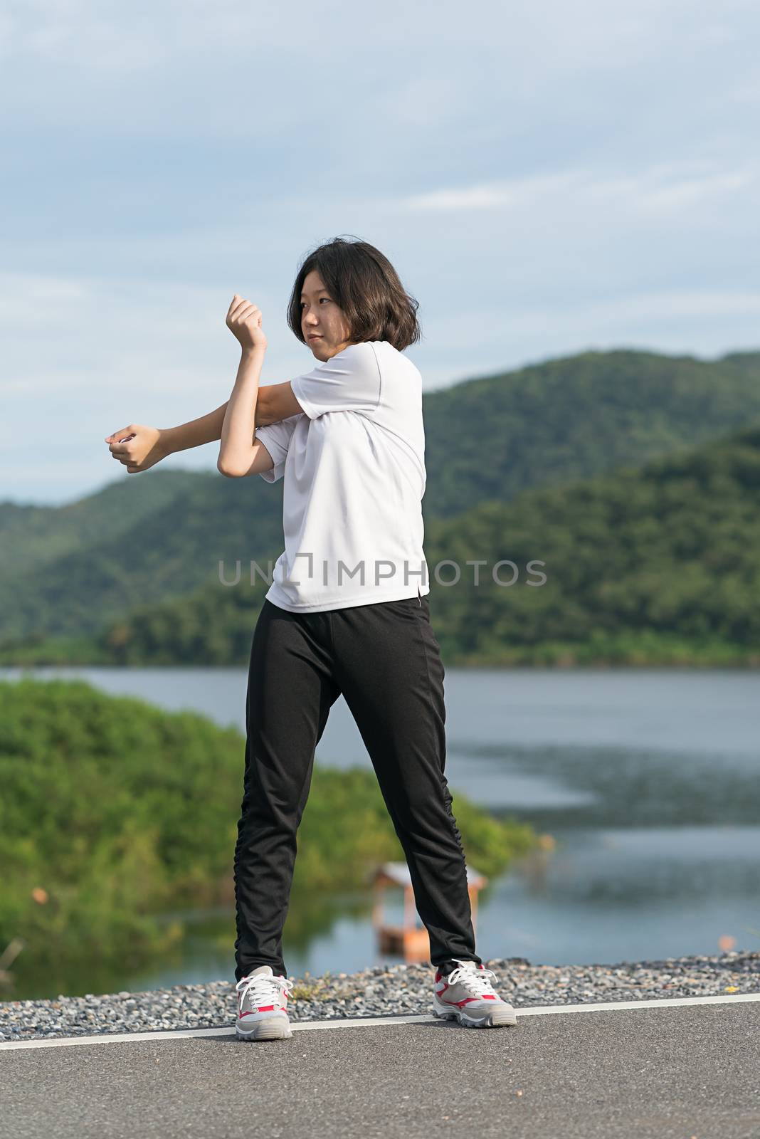 Woman short hair doing exercising outdoor by stoonn