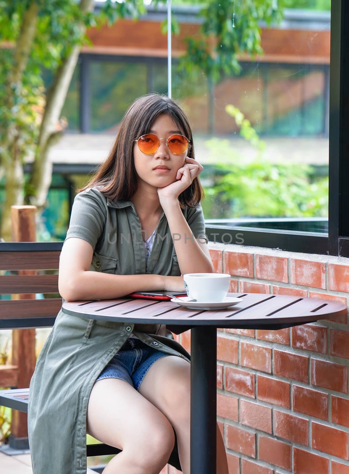 woman sitting in a cafe terrace by stoonn