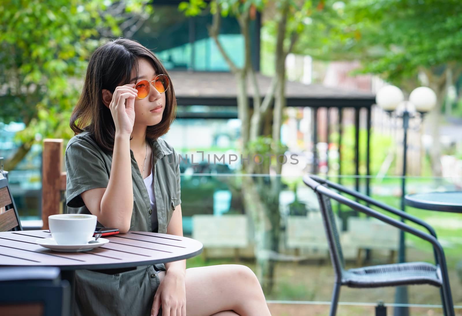 woman sitting in a cafe terrace by stoonn