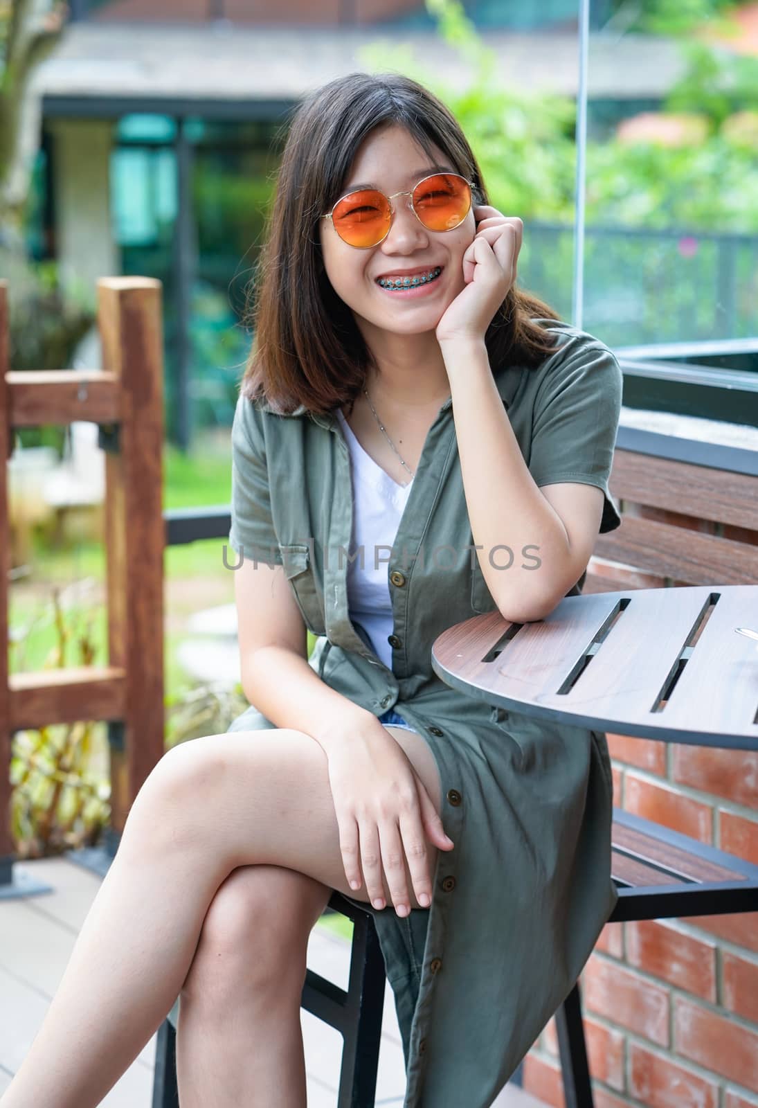 woman sitting in cafe terrace by stoonn