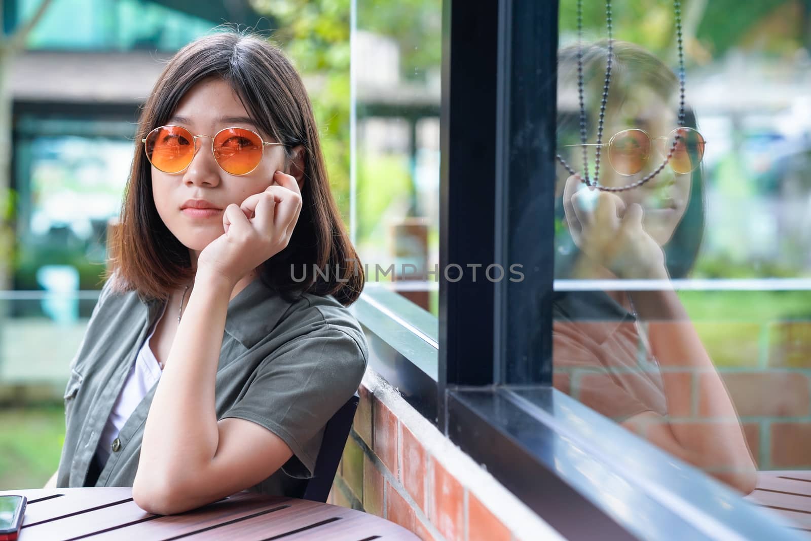 woman sitting in cafe terrace by stoonn