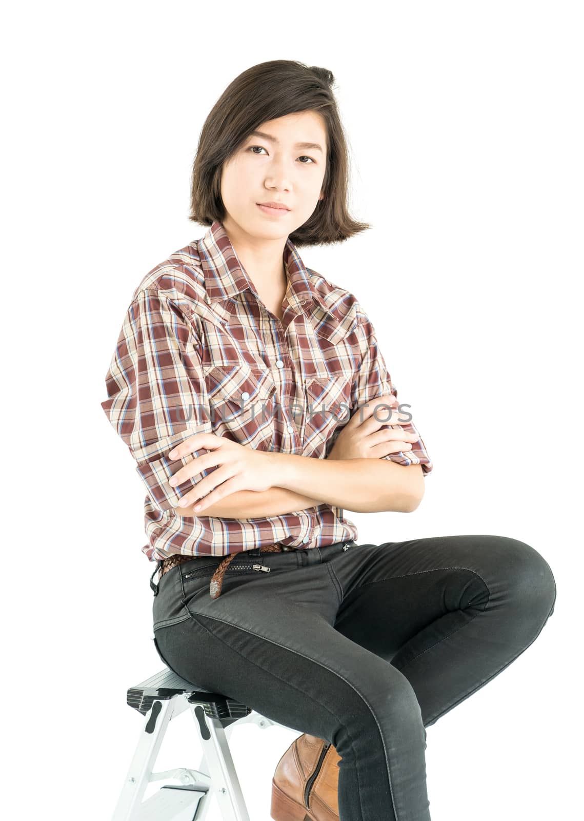 Young pretty woman in plaid shirt posing in studio with isolated on white background