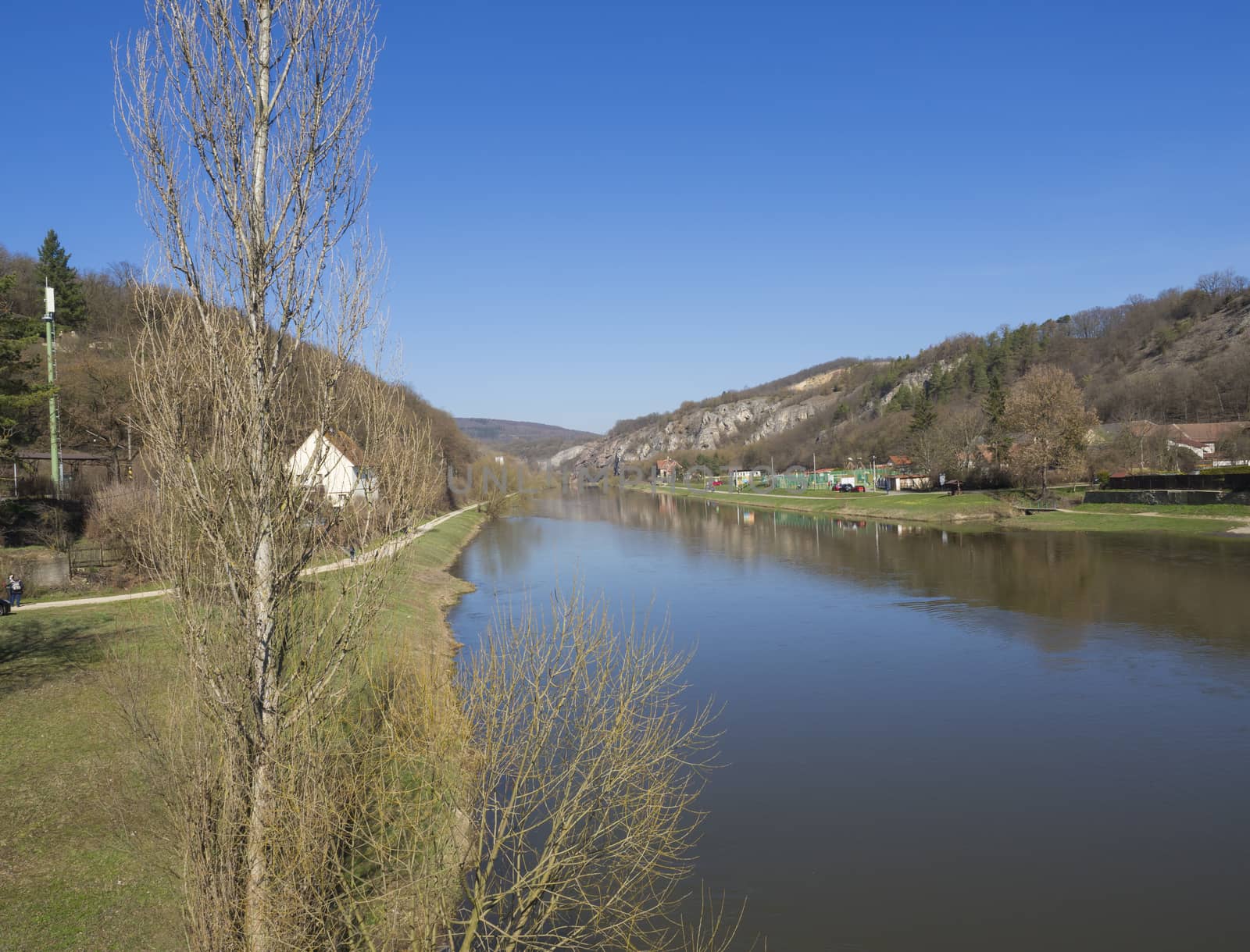 view on river Berounka from pedestrial bridge in village Srbsko in central Bohemian region on on spring sunny day, blue sky.