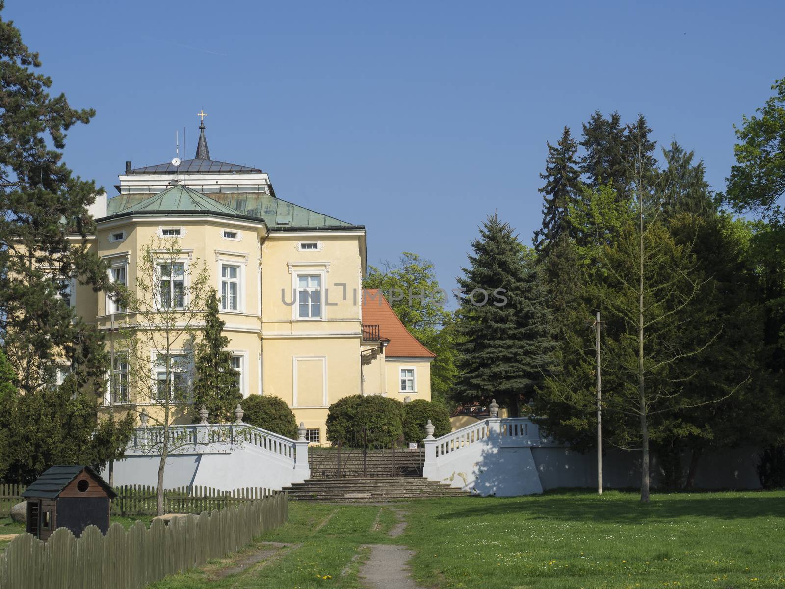 Czech Republic, Prague, Dolni Pocernice, April 21, 2018: 18 th century castle Dolni Pocernice with stairs, castle garden park and blue sky background